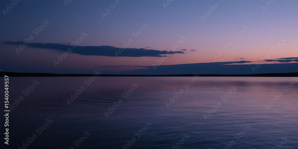 Fototapeta premium Twilight Sky with Purple and Blue Reflections on Calm Water and Soft Clouds on the Horizon