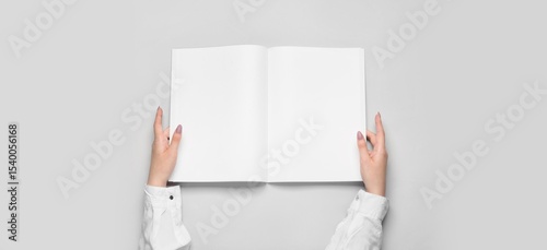 Hands holding blank brochur...