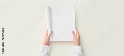 Hands holding blank brochur...