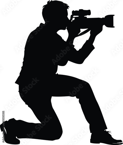 Silhouette of a kneeling photographer aiming camera, capturing a special moment