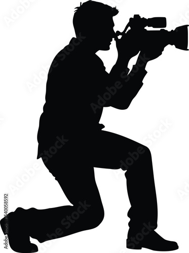 Silhouette of a kneeling cameraman with professional video equipment in black