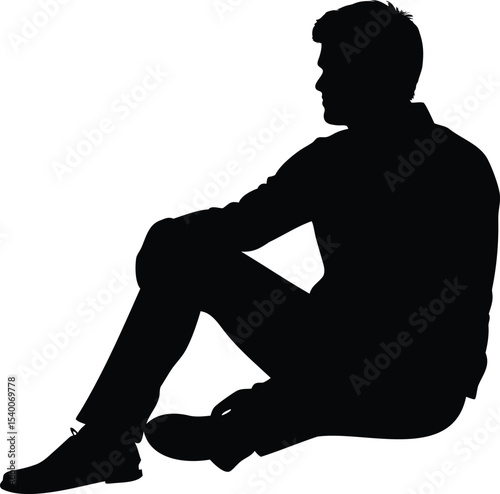 Silhouette of a man sitting on the ground in thoughtful pose