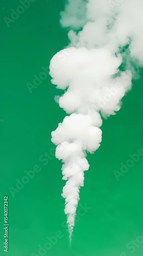 White smoke rising against a green background. The smoke forms a spiral shape, creating a striking contrast with the vibrant green color.