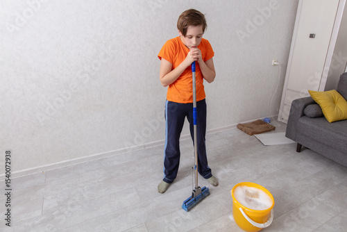 Young person cleaning a room while preparing to mop the floor