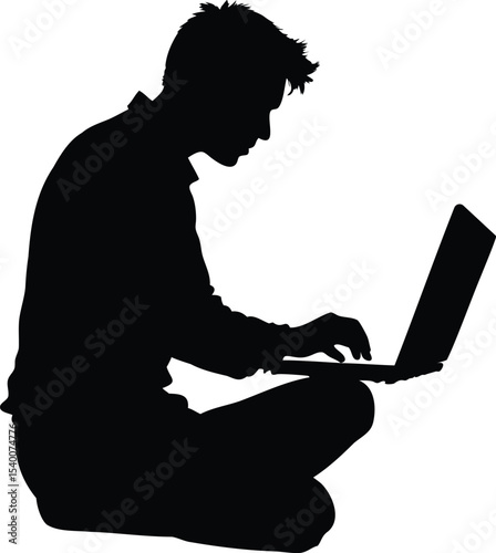 Silhouette of a man sitting crosslegged while using a laptop computer