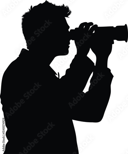 Silhouette of a man with a camera, observing or filming something far away