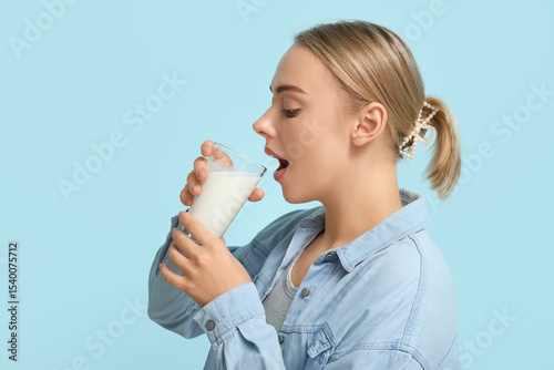 Pretty young woman drinking...