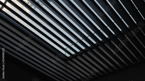 Black slatted roof. Modern architectural design of the house. Terraced roof against the background of trees, combining beautiful views of nature.