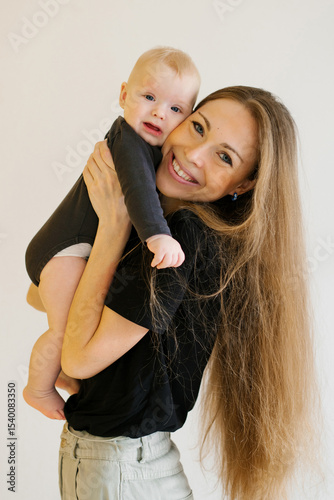 Smiling Mother Holding Baby Boy