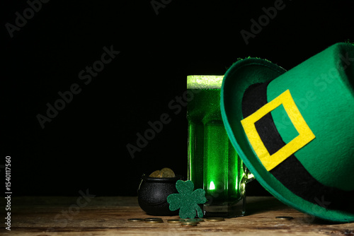 Glass of green beer with cl...