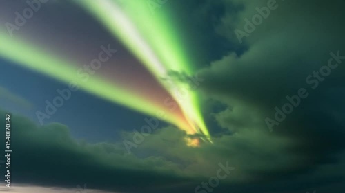 Luminous Green And Orange Light Beams Breaking Through Dramatic Dark Storm Clouds Against Blue Sky