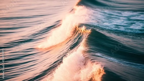 Close Up Aerial View of Breaking Ocean Waves with Golden Sunset Lighting and Foamy White Crests