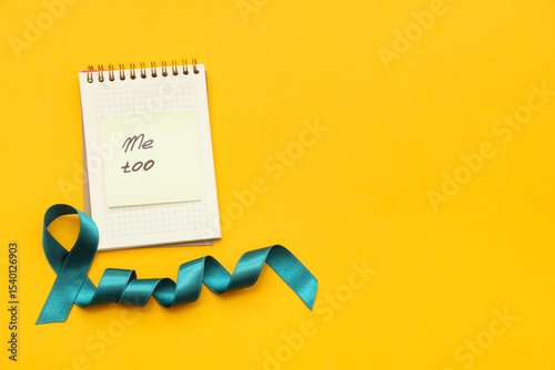 Teal ribbon and notebook wi...