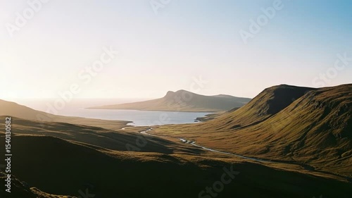 Elevated Aerial View of Lush Green Mountains and Valley with a Calm Body of Water during Daylight