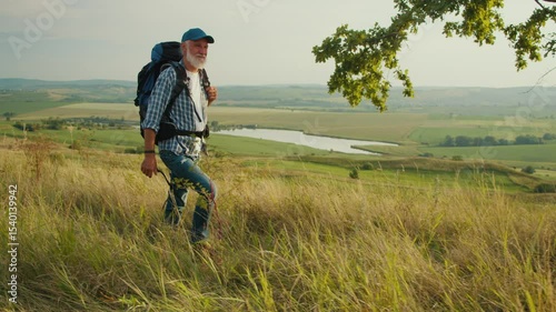 Purposeful Journey, Late-Life Exploration. Senior Man Hikes Through Panoramic Mountain Landscape, Surrounded by Trees, Grass, and Sky. A Soulful Adventure Embracing Nature and Personal Growth in Later