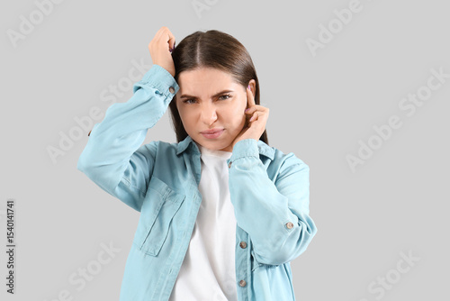 Young woman with otitis on ...