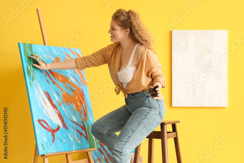 Female artist painting with...