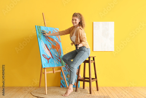 Female artist painting with...