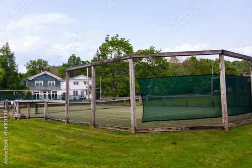 Lawn tennis court and central green seen during a late spring day, Georgeville, Quebec, Canada
