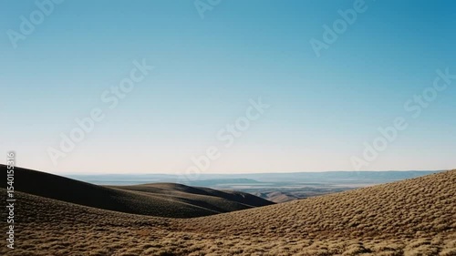 Panoramic Landscape View With Brown Hills And Blue Sky Under Sunlight During Day