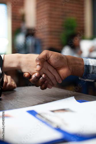 Closeup of people handshaking in office