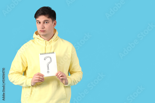 Young man holding notebook ...