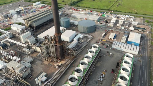 Aerial drone view petrochemical refinery and power plant in Immingham England UK. Smoke stacks, plumes of smoke, industrial piping energy park petrochemical silos.
