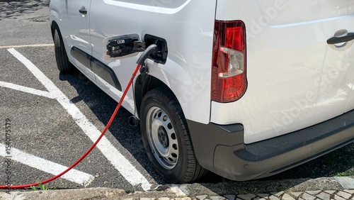 Electric van sipping energy through a vibrant cord, an ode to Earth Day's eco-revolution and sustainable innovation May 23, 2025, Lisbon, Portugal