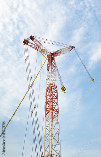 Crane boom. Part of big crane, crawler crane or derrick crane. Machine equipment with hoist, hook and steel truss structure for heavy load lifting in construction industry and assembly work.