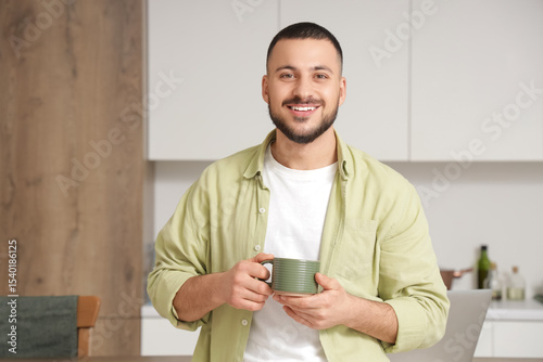 Young man with ceramic cup ...