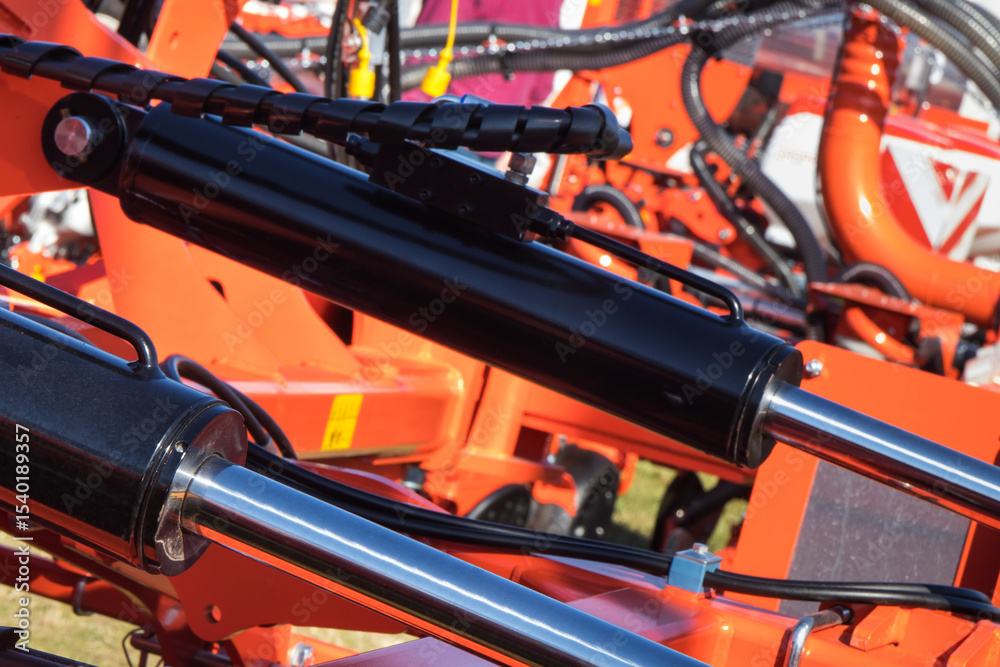 Fototapeta premium Black pistons or actuators in red pneumatic or hydraulic machine. Technology