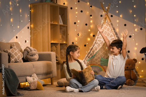 Cute children reading adven...
