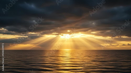 Dramatic sunset over ocean with crepuscular sun rays piercing through dark clouds