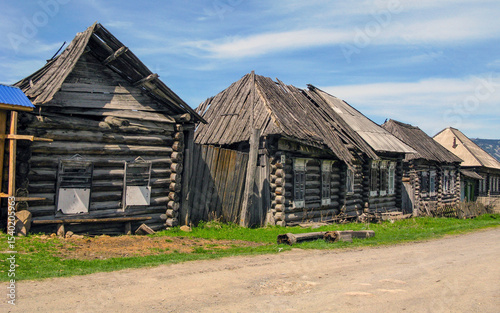 Village street in the taiga village of Nikolaevka in the Southern Urals on a sunny summer day