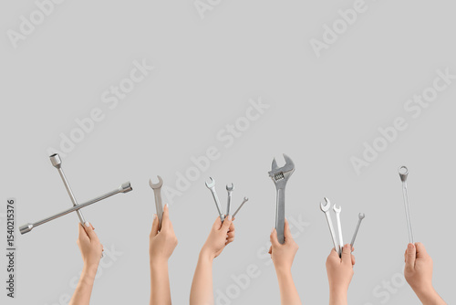 Many hands with wrenches on...