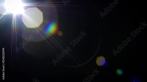 Bright lens flare circle with transparent rainbow refraction and radial glow, black void