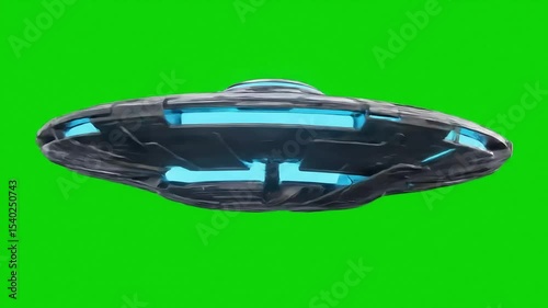 Futuristic ufo flying saucer against a bright green screen ready for compositing