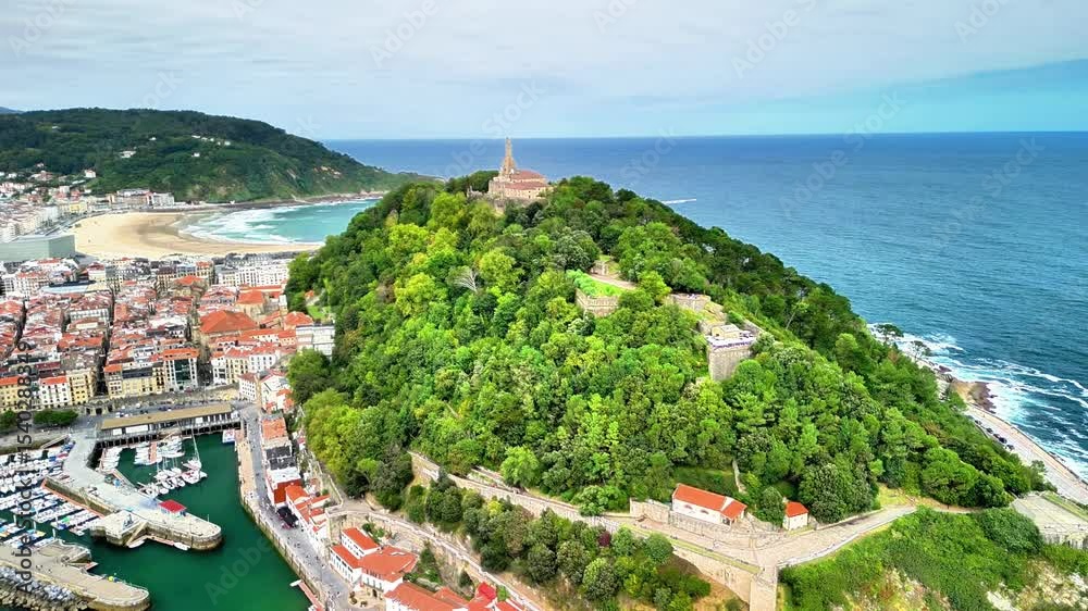 This stunning aerial shot beautifully showcases the picturesque Monte Igueldo, dramatically overlooking La Concha Beach