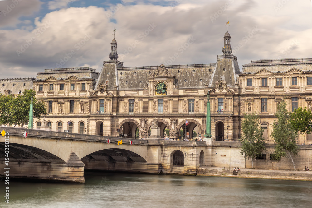 Louvre Museum and Pont du Carrousel bridge over Seine River in Paris Louvre Museum and Pont du Carrousel bridge over Seine River in Paris