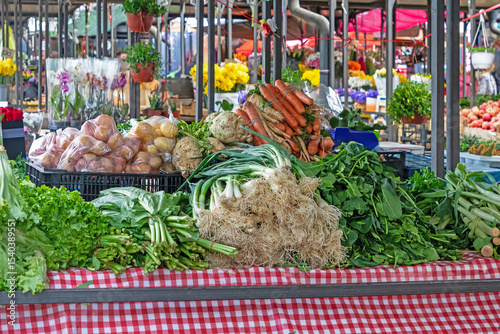 Pile of fresh organic raw vegetables outside on a market stall