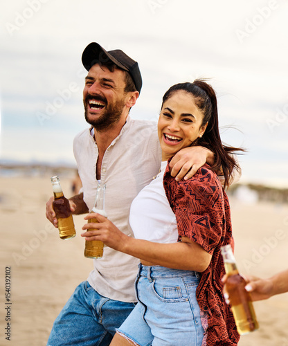 Obraz na plátně Group of young cheerful people, happy couple in front,  having fun walking and d