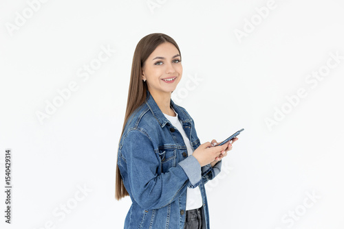 Happy pretty young woman model holding smartphone looking at camera, smiling girl using mobile apps on cell phone standing isolated on white background with cellphone.