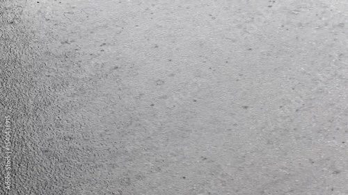 A big puddle from the rain, a typhoon is starting, the wind has brought a cyclone. The weather is rainy, raindrops on the water.