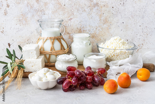 Fresh dairy products, milk, cottage cheese, yogurt, kefir, feta cheese on kitchen table	