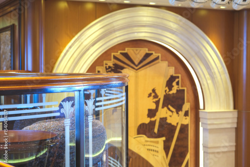 Opulent Art Deco interior architecture inside lobby, atrium or foyer on modern ocean liner style cruiseship cruise ship with staircase, corridors, carpets, chandeliers and art work