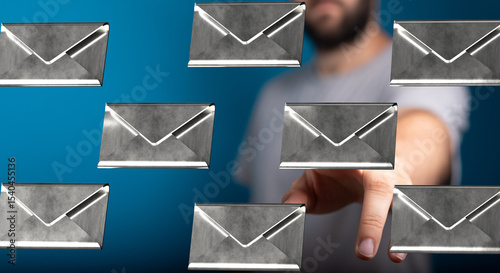 Image of a man interacting with digital email icons, representing communication and technology.