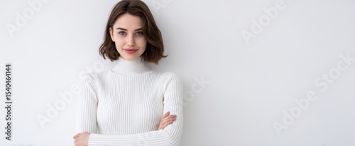 The confident woman in a stylish white sweater showcasing elegance and poise.