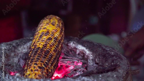 Roasting corn at food stall, Mumbai city, India