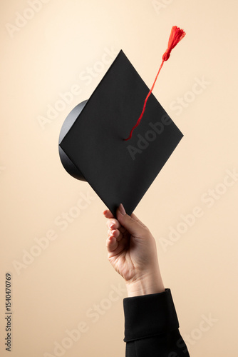 hand holding graduation cap