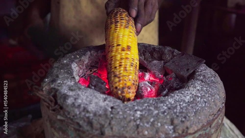 Roasting corn at food stall, Mumbai city, India